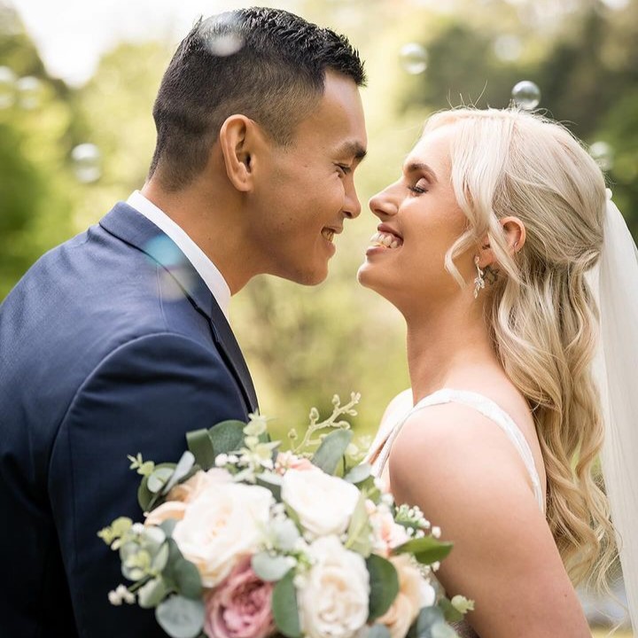 Bride with a sleek ponytail and soft glam bridal makeup