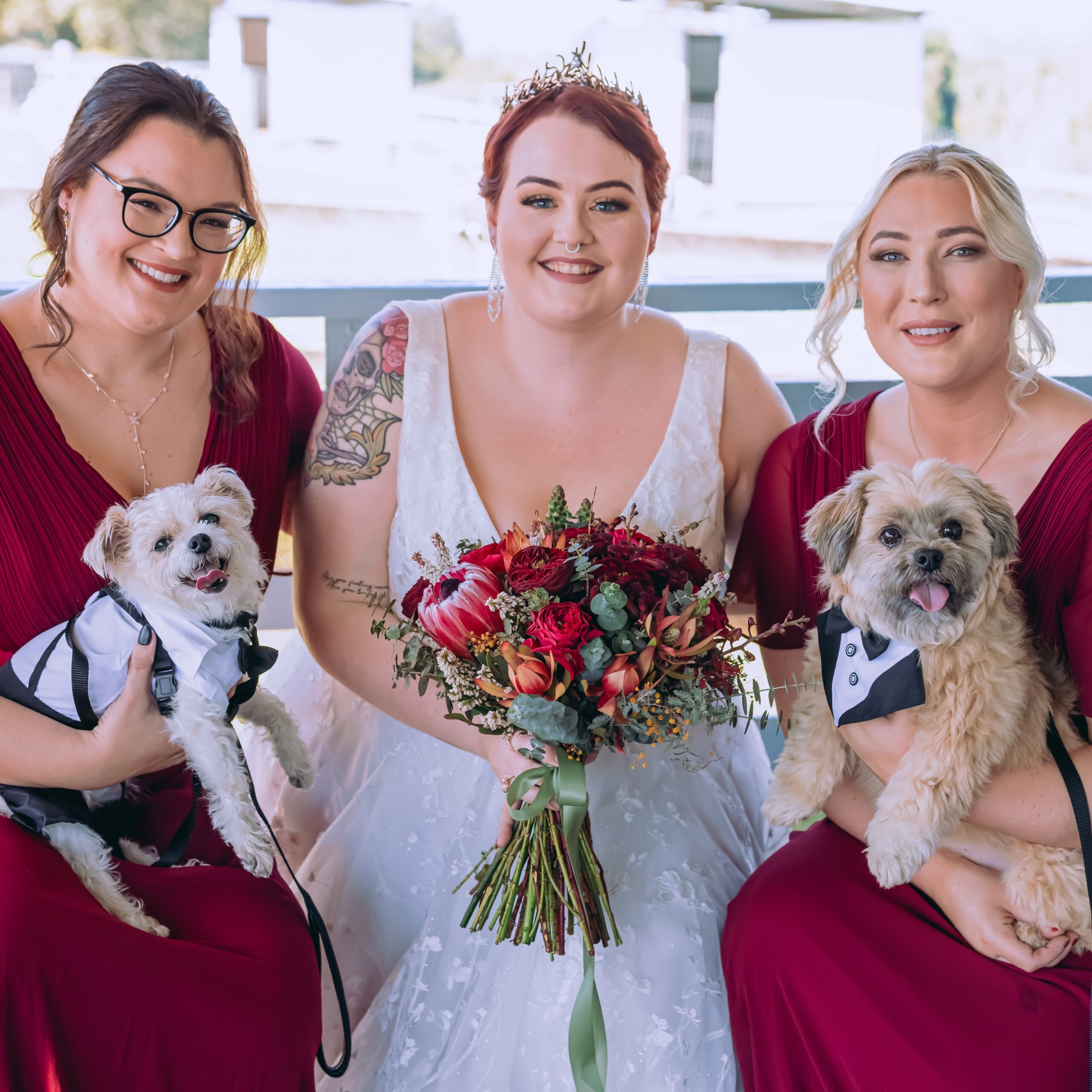 Bride and bridesmaids in burgundy with coordinated hair and makeup